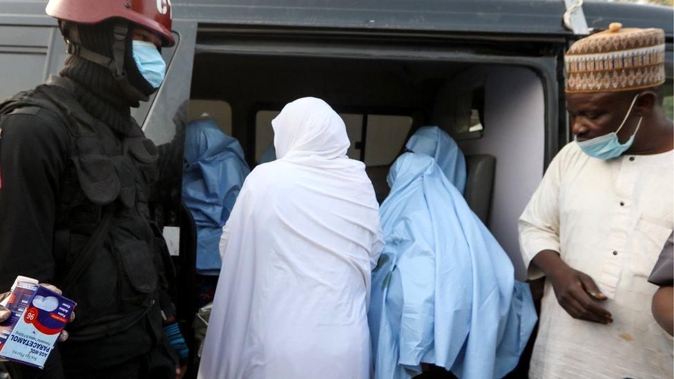 Girls kidnapped from a boarding school in the northwest Nigerian state of Zamfara, get into a vehicle after their release in Zamfara, Nigeria, 2 March 2021