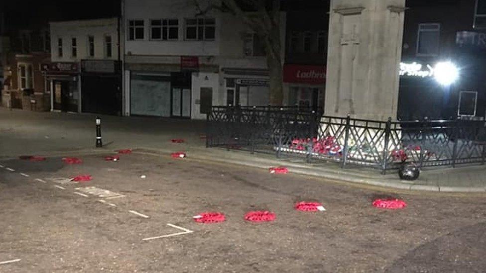 Poppy wreaths strewn on the ground