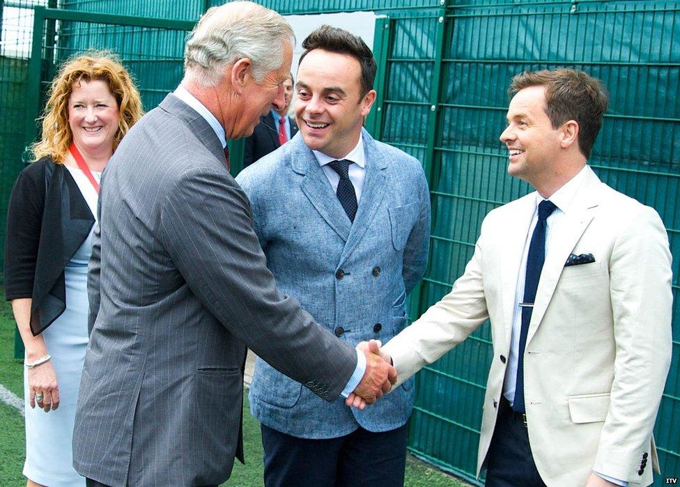 Prince Charles shakes hands with Dec, watched by Ant