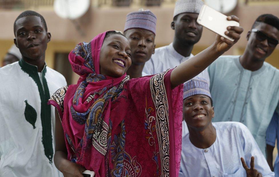 A Nigeria woman taking photograph after Eid al-Adha at the prayer ground in Lagos, Nigeria, Monday 12 September 2016