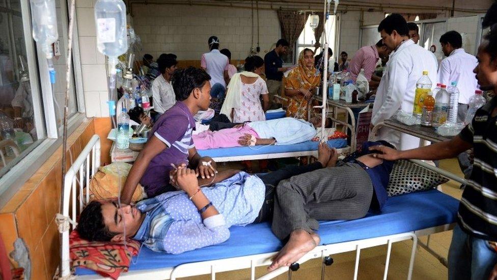 Indian dengue patients share a bed in a ward of The Hindu Rao hospital in New Delhi on September 16, 2015.