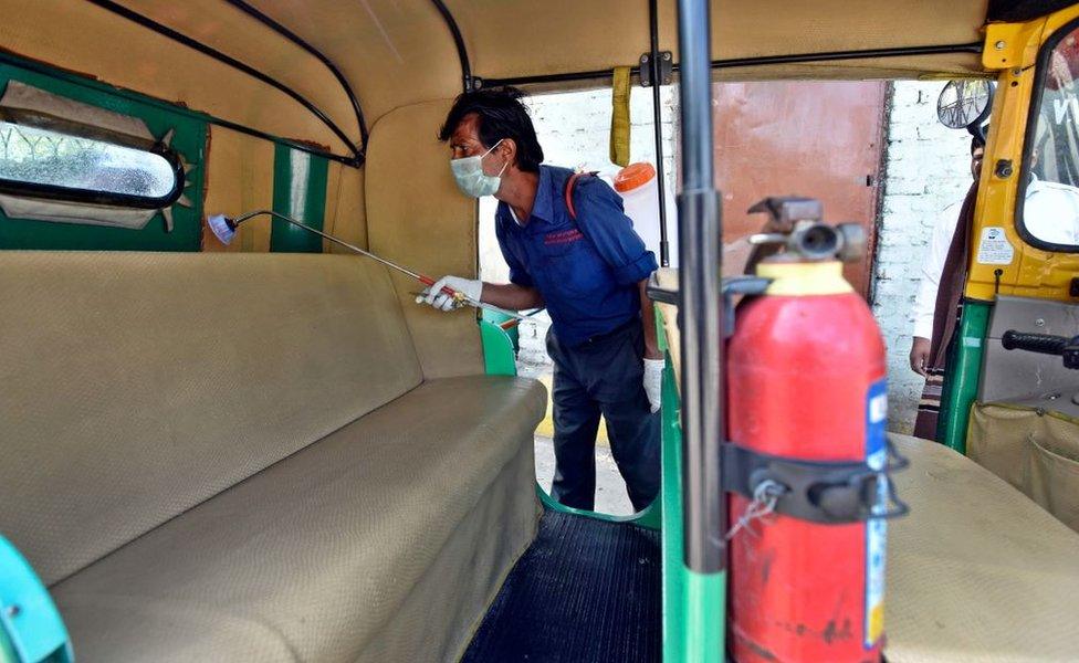 DTC cleaning staff chemically disinfect and sanitize auto rickshaw as a precautionary measure in view of coronavirus concerns, at Vasant Vihar Depot on March 17, 2020 in New Delhi, India.