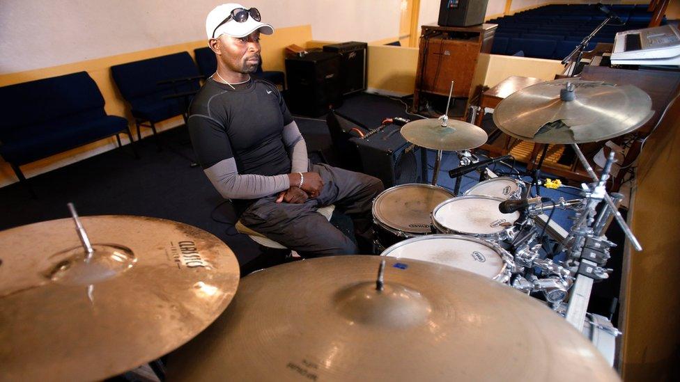 Fred Banks, uncle of 31-year-old Corey Jones who was fatally shot by a South Florida police officer, sits at the drum set that Jones played in church, as he speaks to members of the media at Bible Church of God Church, Wednesday, Oct. 21, 2015, in Boynton Beach, Fla.