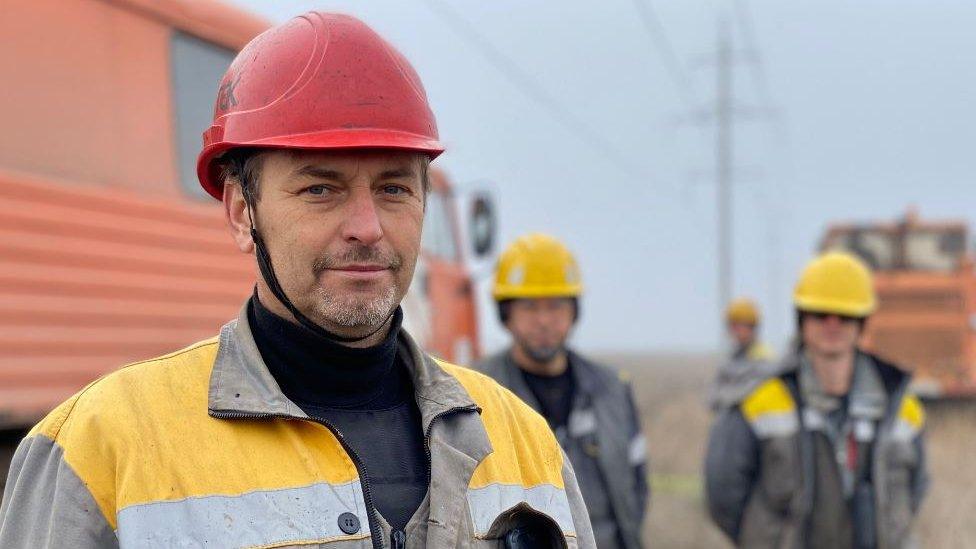 Three men looking at camera wearing hard hats