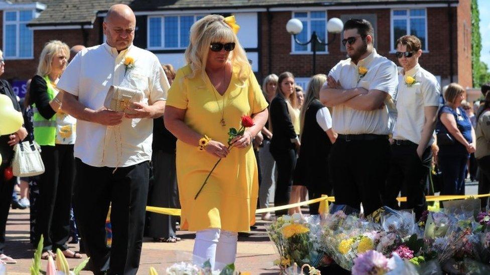 Parents Lesley and Simon with brothers Daniel and Harry lay flowers