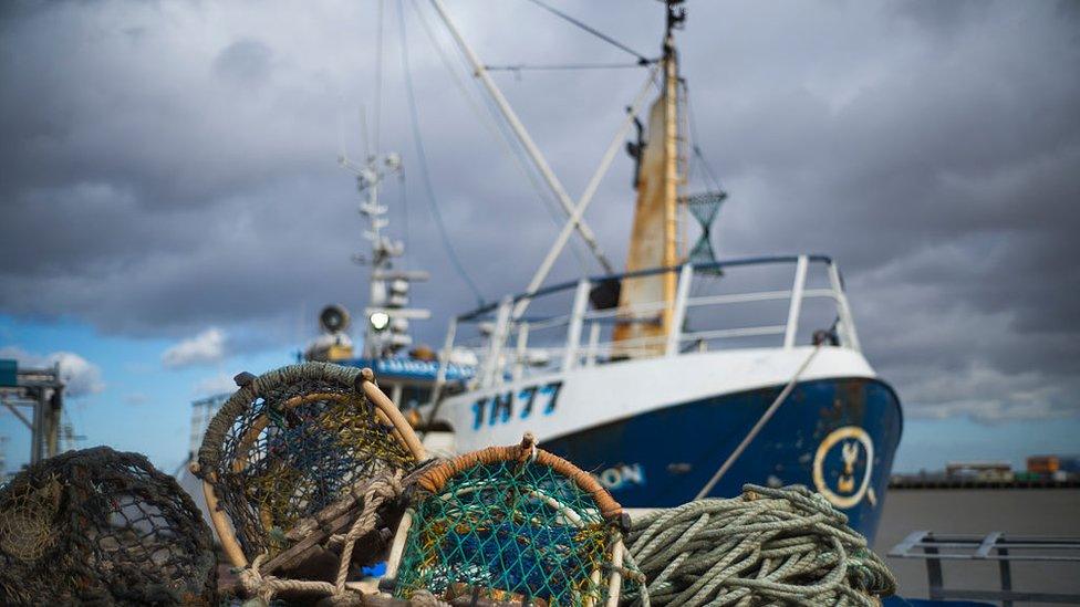 A trawler sits at the dockside of Grimsby Fish Market