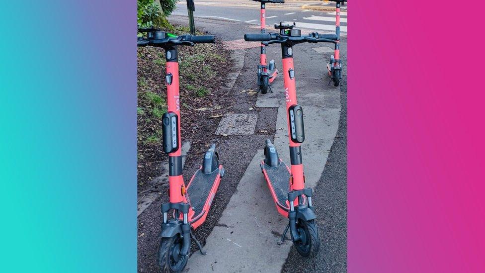 four-e-scooters-parked-on-pavement