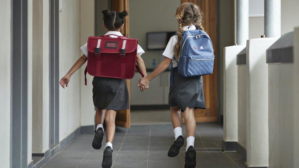 Girls running to school