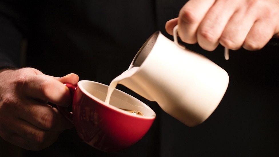 Milk jug and coffee cup - stock image