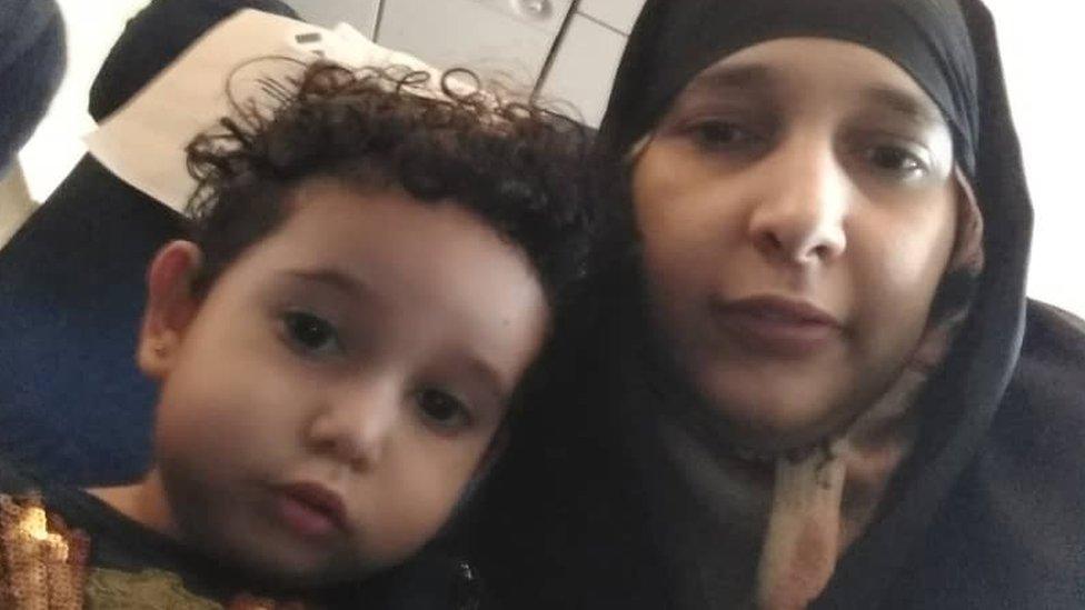 Safia Saleh and her two-year-old Asalah on the plane from Yemen