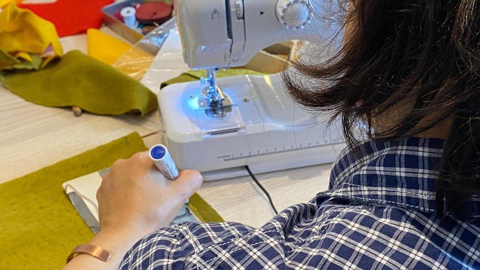 A woman at a sewing machine