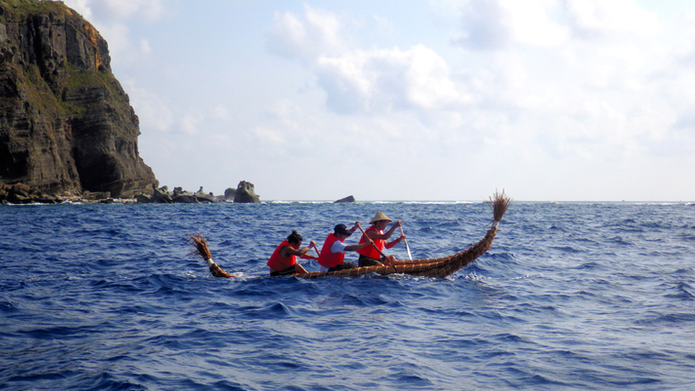 Scientists in a straw boat on an earlier trip