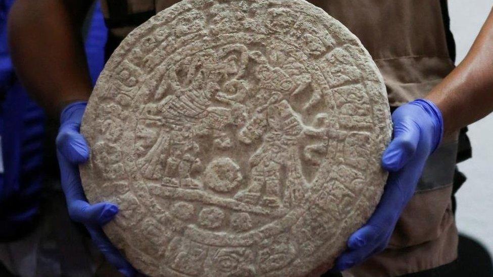 A worker shows a circular-shaped Mayan scoreboard used for a ball game found at Chichen Itza's archaeological site during a news conference, in Merida, Mexico April 11, 2023.