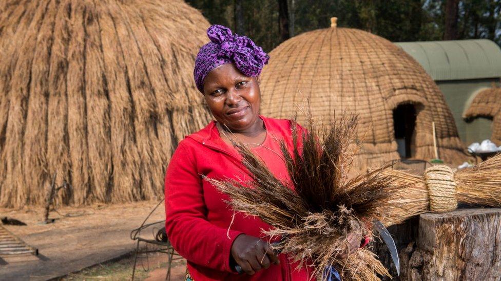 A woman making a beehive hut at the Mlilwane Wildlife Sanctuary.