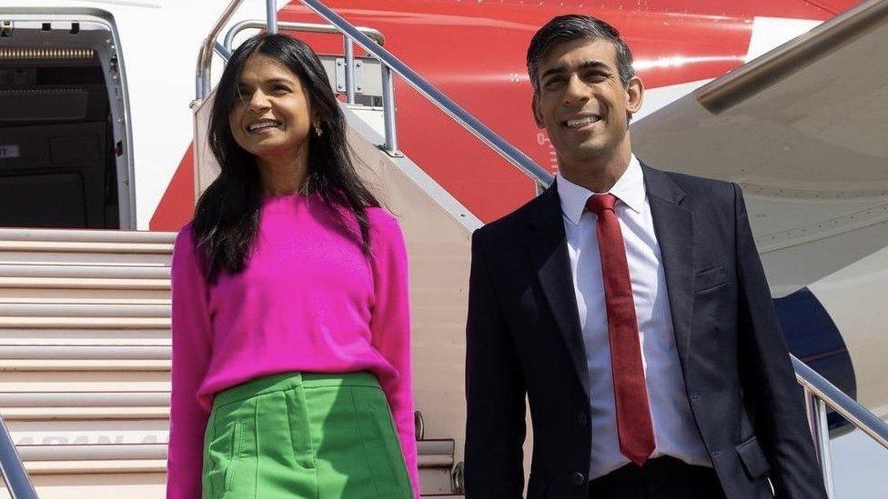 Prime Minister and his wife coming off a plane