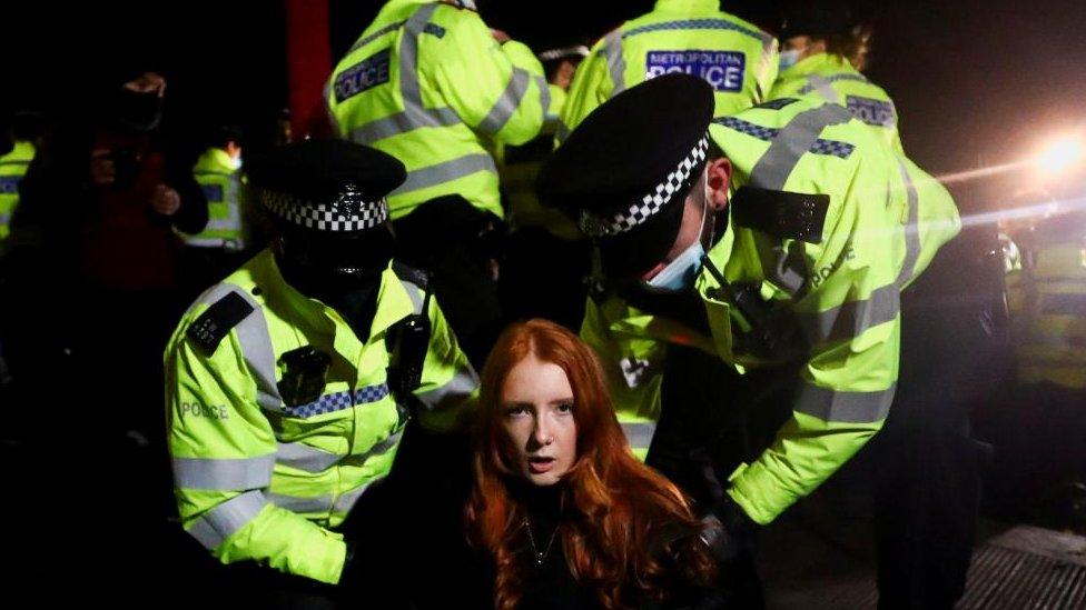 Police detain Patsy Stevenson as people gather at a memorial site in Clapham Common Bandstand