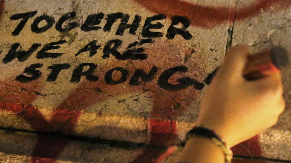 Together We Are Strong is written on a statue the day after the Paris terror attacks