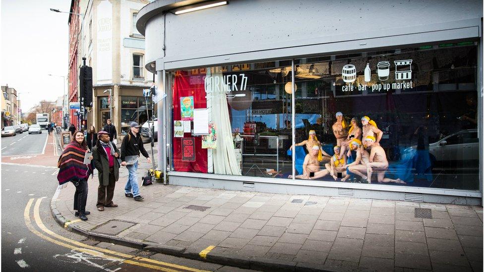 People posed in a window in Bristol