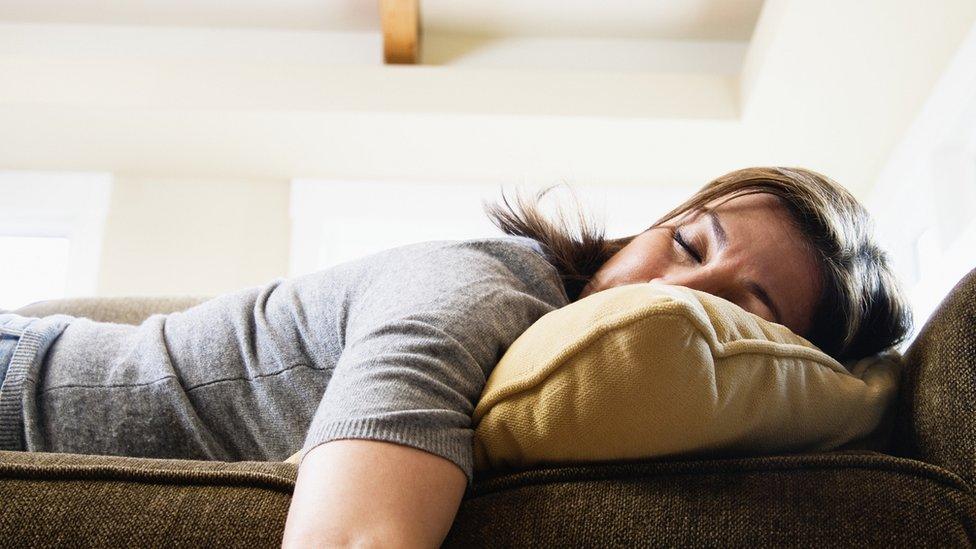 woman lying on sofa