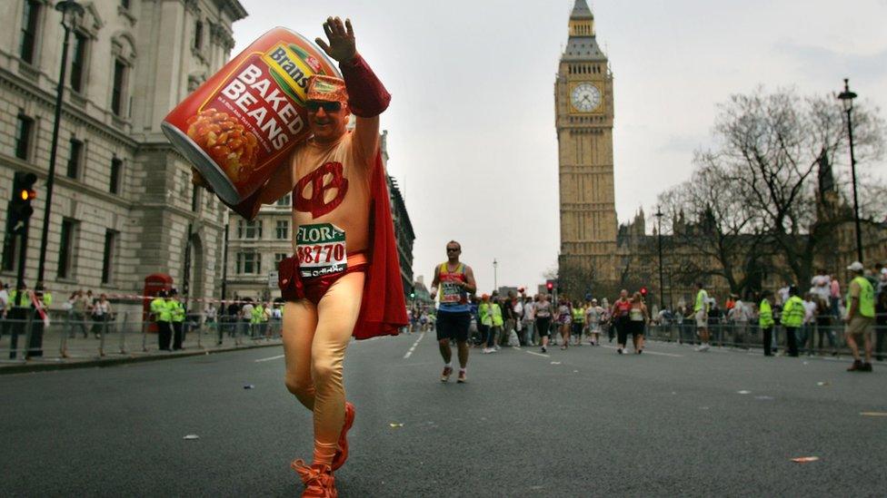 A runner carrying an oversized can of baked beans passes Big Ben in 2007