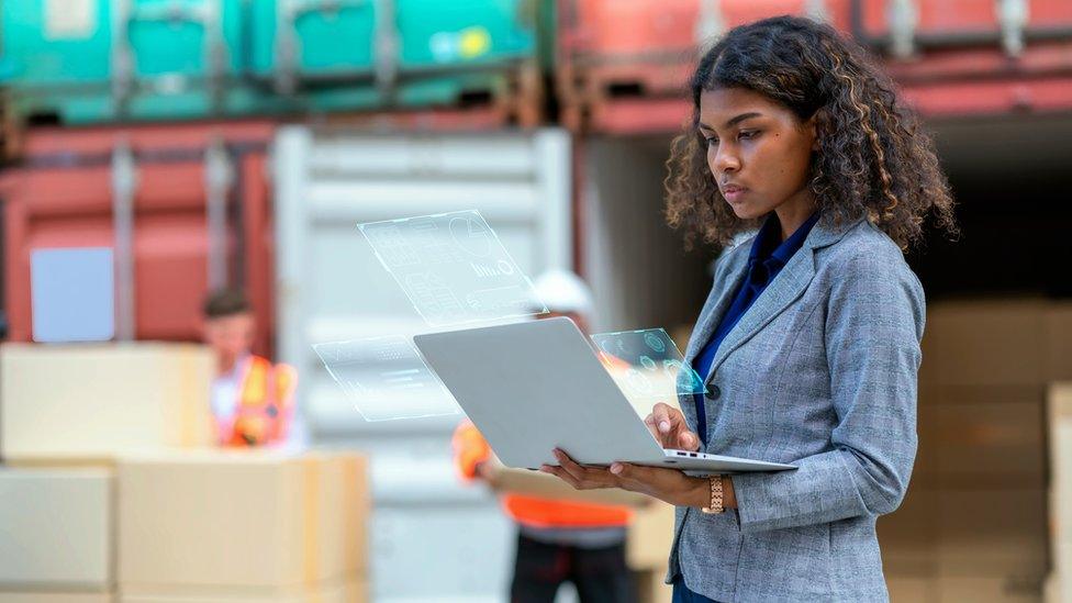 A woman using a laptop in a port