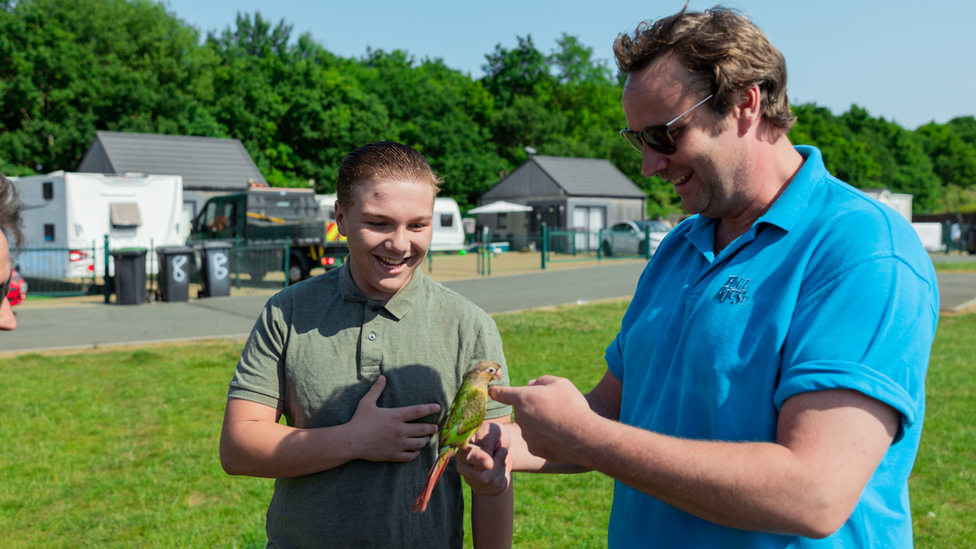 Boy being shown a bird