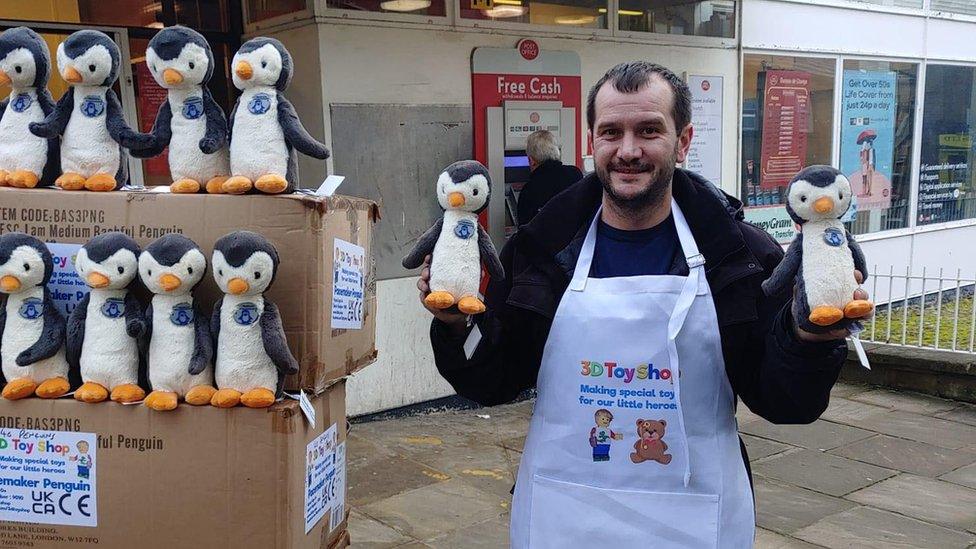 Nick Hardman with penguins that have been fitted with a pacemaker