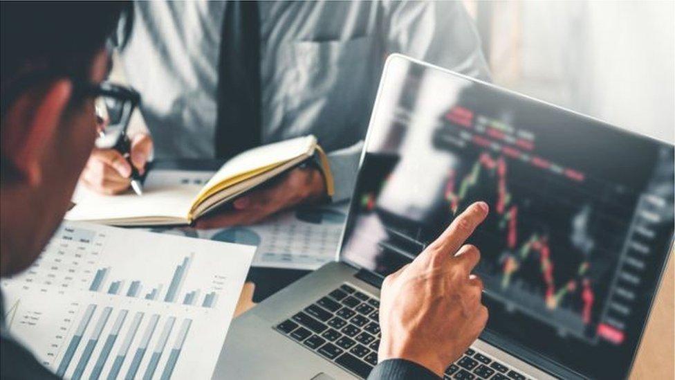 Stock image of man working on financial charts