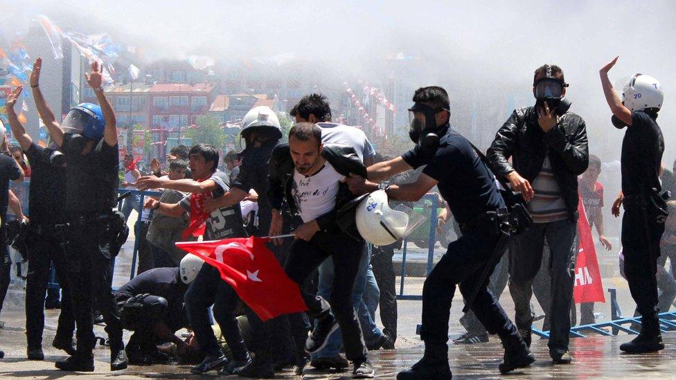 People clash with Turkish riot police in Erzurum, in June 2015