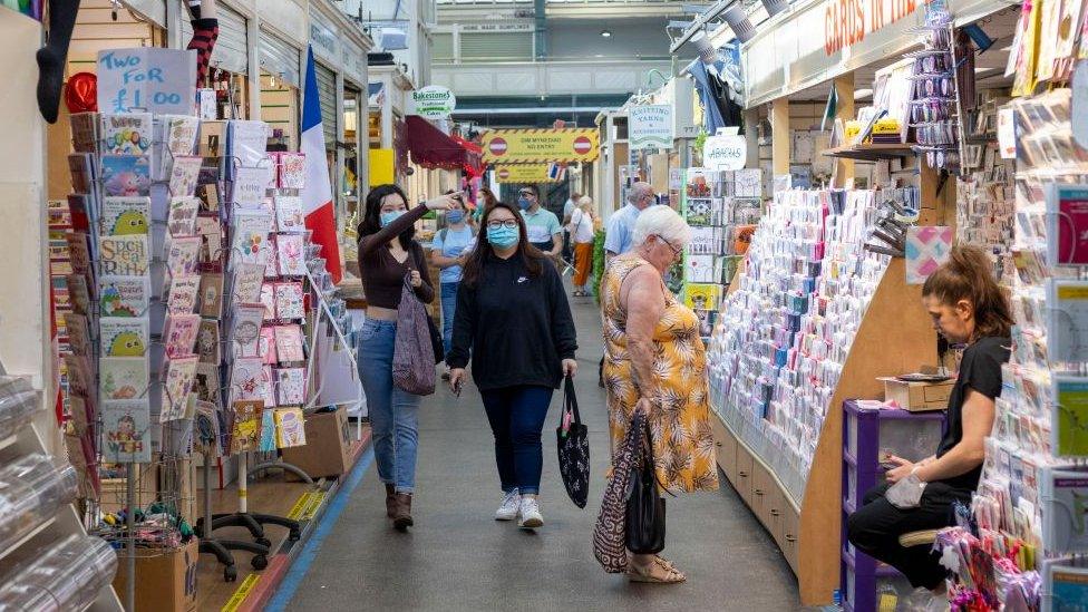 People walking through Cardiff market