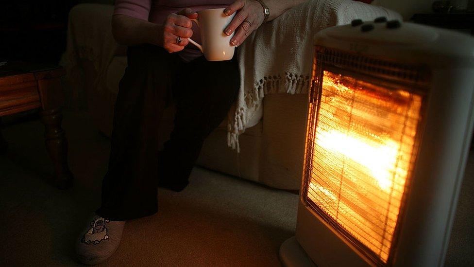 Women by electric heater