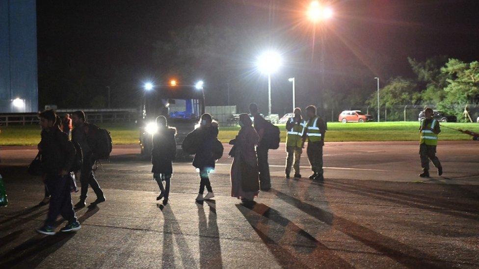 British nationals and Afghan evacuees depart a flight from Afghanistan at RAF Brize Norton