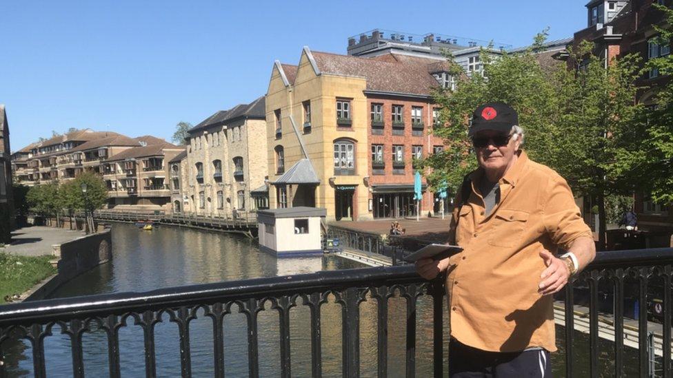 Woody stood in front of a bridge in Cambridge