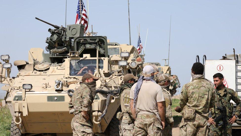 Kurdish fighters from the People"s Protection Units (YPG) chat with members of US forces in the town of Darbasiya next to the Turkish border, Syria April 29, 2017