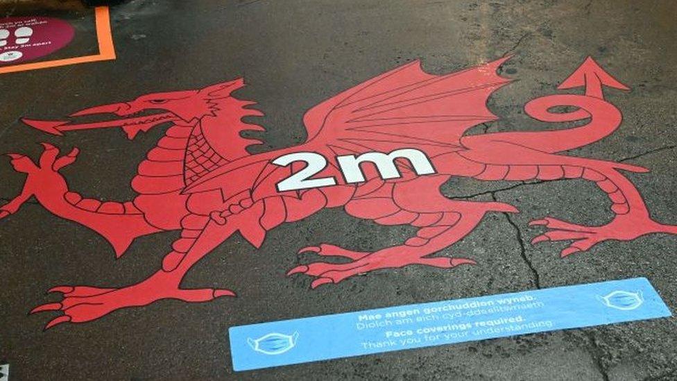 A distance warning painted on a pavement in Wrexham