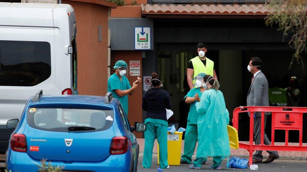 Medical staff prepare to check guests leaving the H10 Costa Adeje Palace