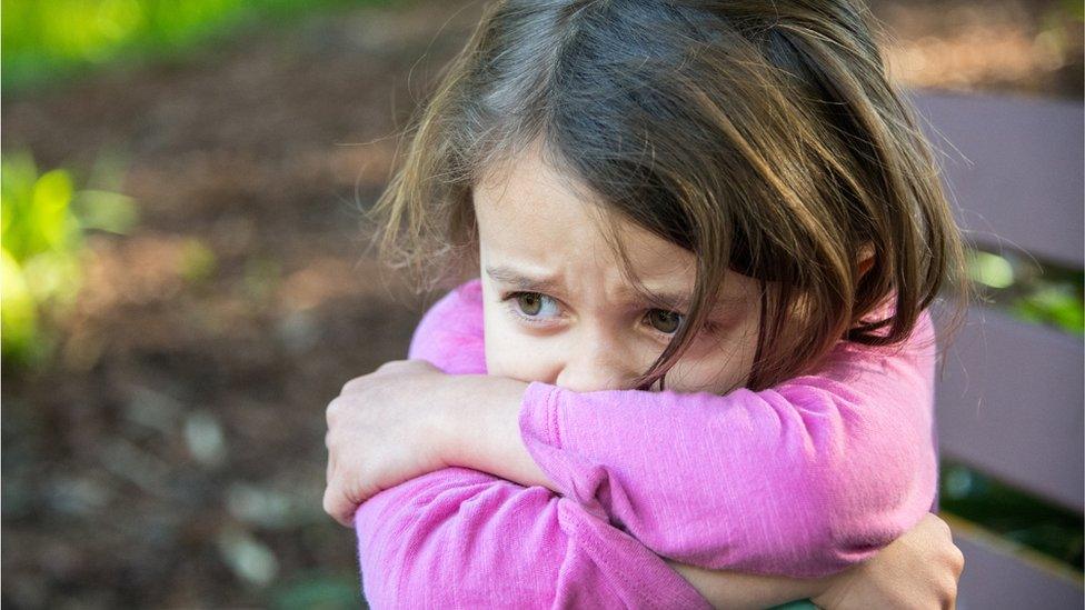 young girl looking scared