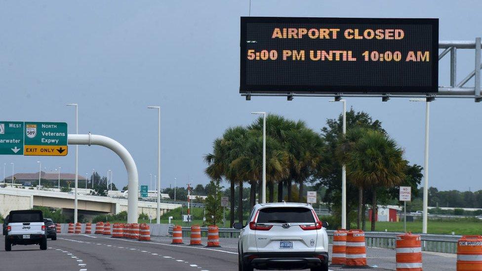 A sign at Tampa International Airport advises motorists of the closing of the airport as Elsa moves north on July 6, 2021