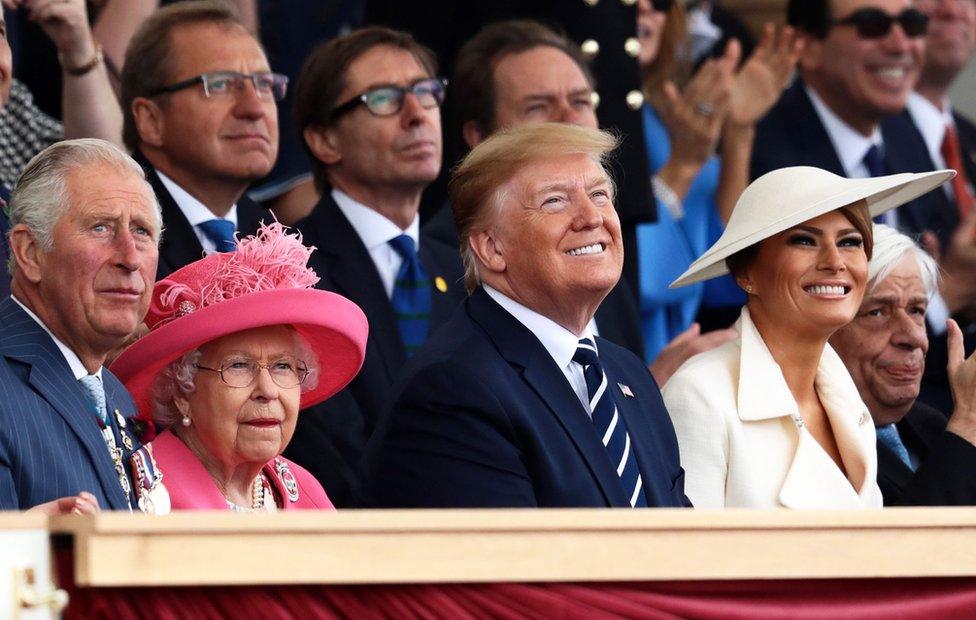 Prince Charles, the Queen and Mr and Mrs Trump look upward