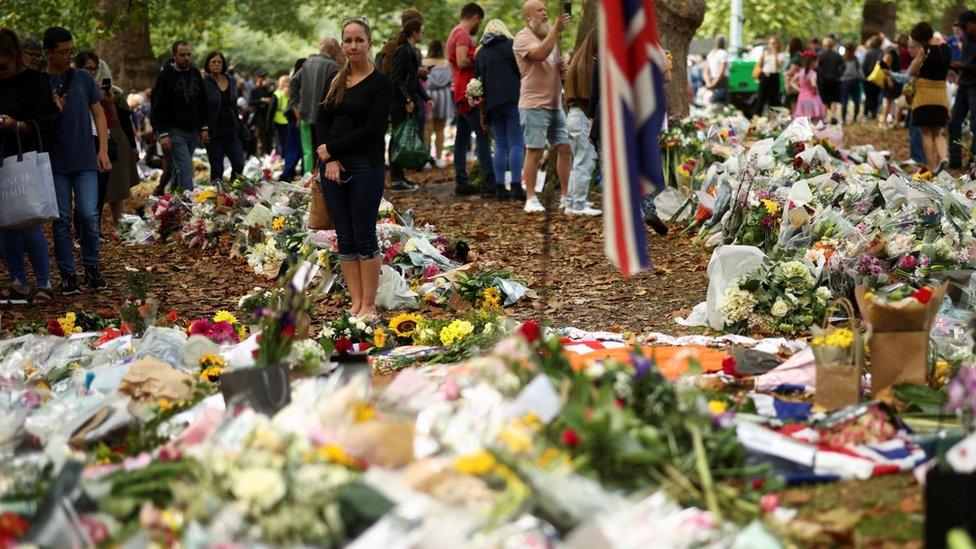 People visit floral tributes placed in Green Park near Buckingham Palace