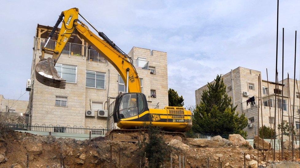 Earth moving equipment stands in the disputed Israeli "settlement" of Ramat Shlomo, 23 December 2016