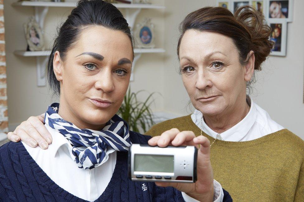 Two women holding up a spy camera