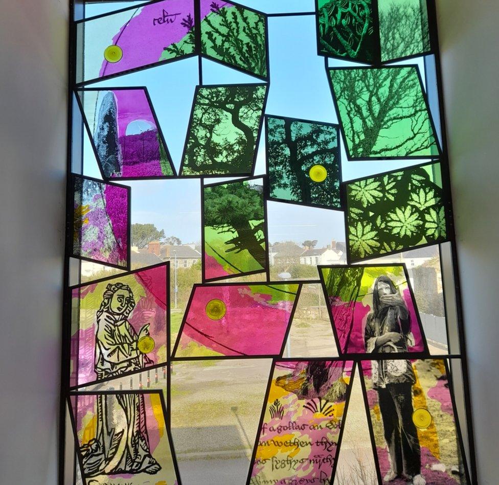 New contemporary stain glass window at Kresen Kernow with panels coloured green, black, yellow and pink