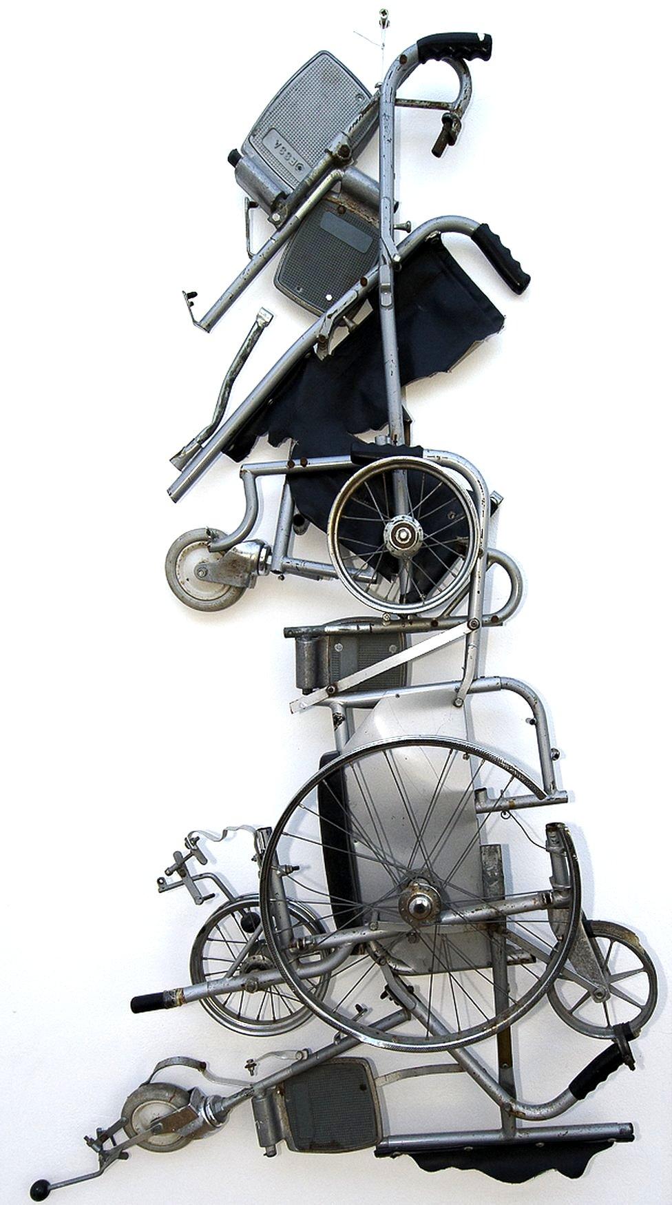 A wheelchair taken to pieces is rearranged into the shape of Great Britain