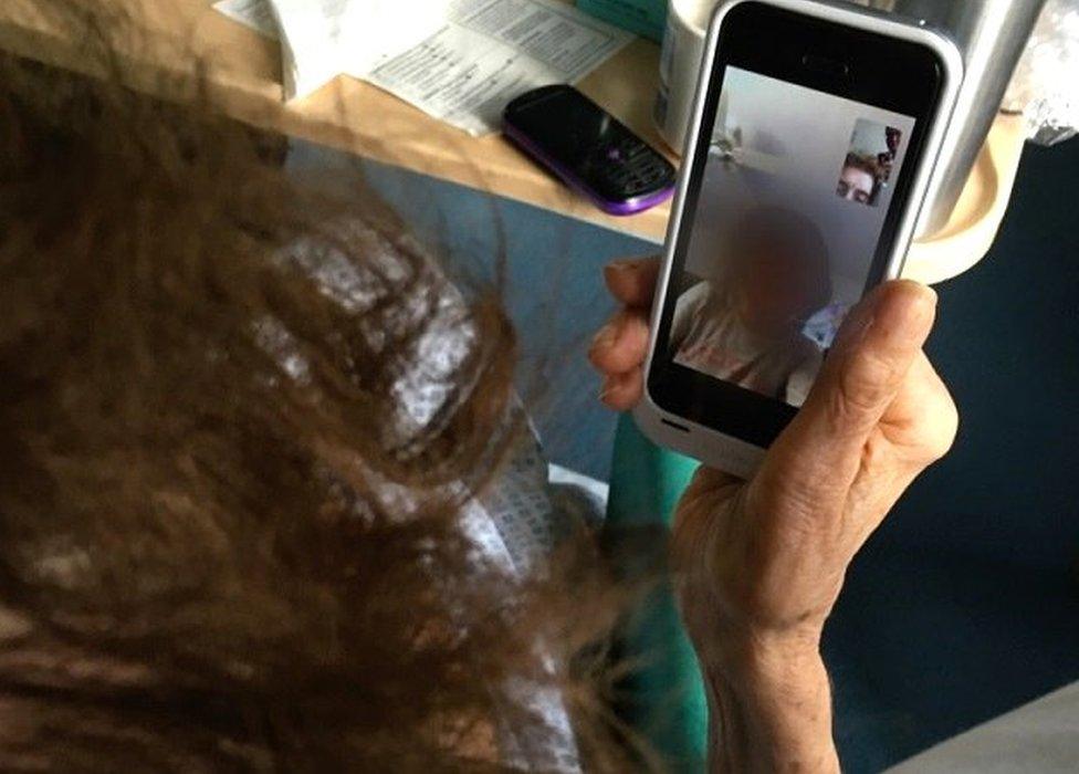 Kathleen talking to her granddaughter on a phone