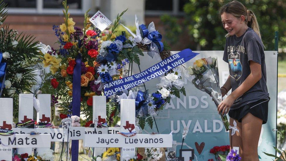 A girl cries as she brings flowers to a memorial for victims following the mass shooting at the Robb Elementary School in Uvalde, Texas, USA, 28 May 2022.