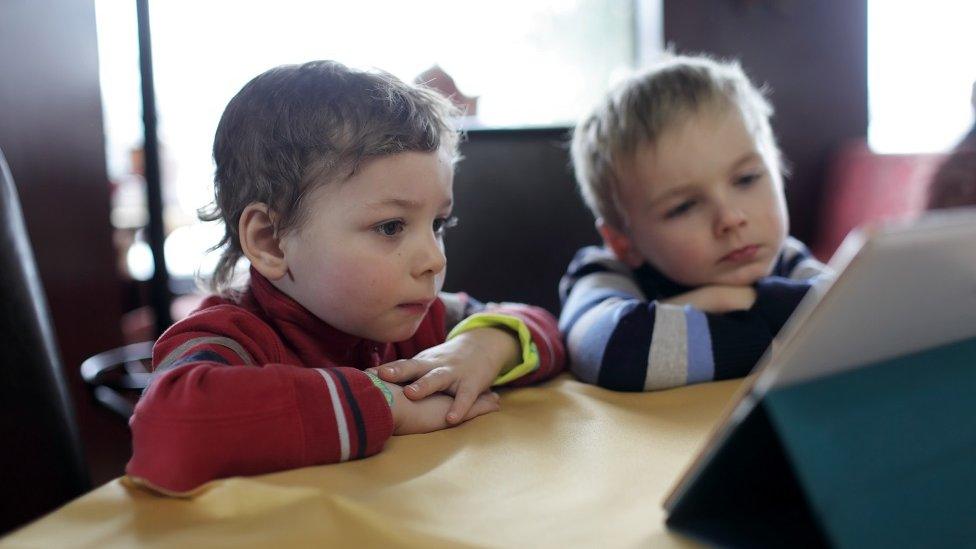 Children looking at a tablet