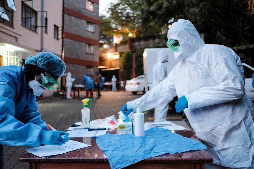 Doctors prepare to administer the mandatory COVID-19 coronavirus test for detainees of a Government designated quarantine facility in Nairobi on March 29, 2020