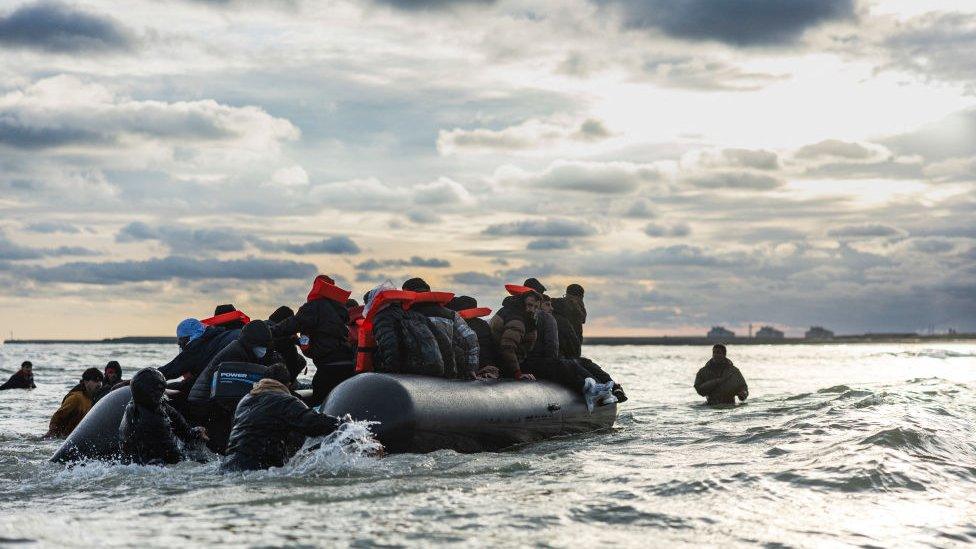 Migrants board a smuggler's boat in an attempt to cross the English Channel, on the beach of Gravelines, near Dunkirk, northern France on April 26, 2024