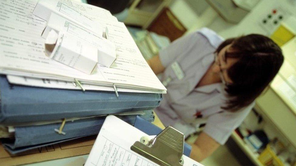 Nurse working on medical records